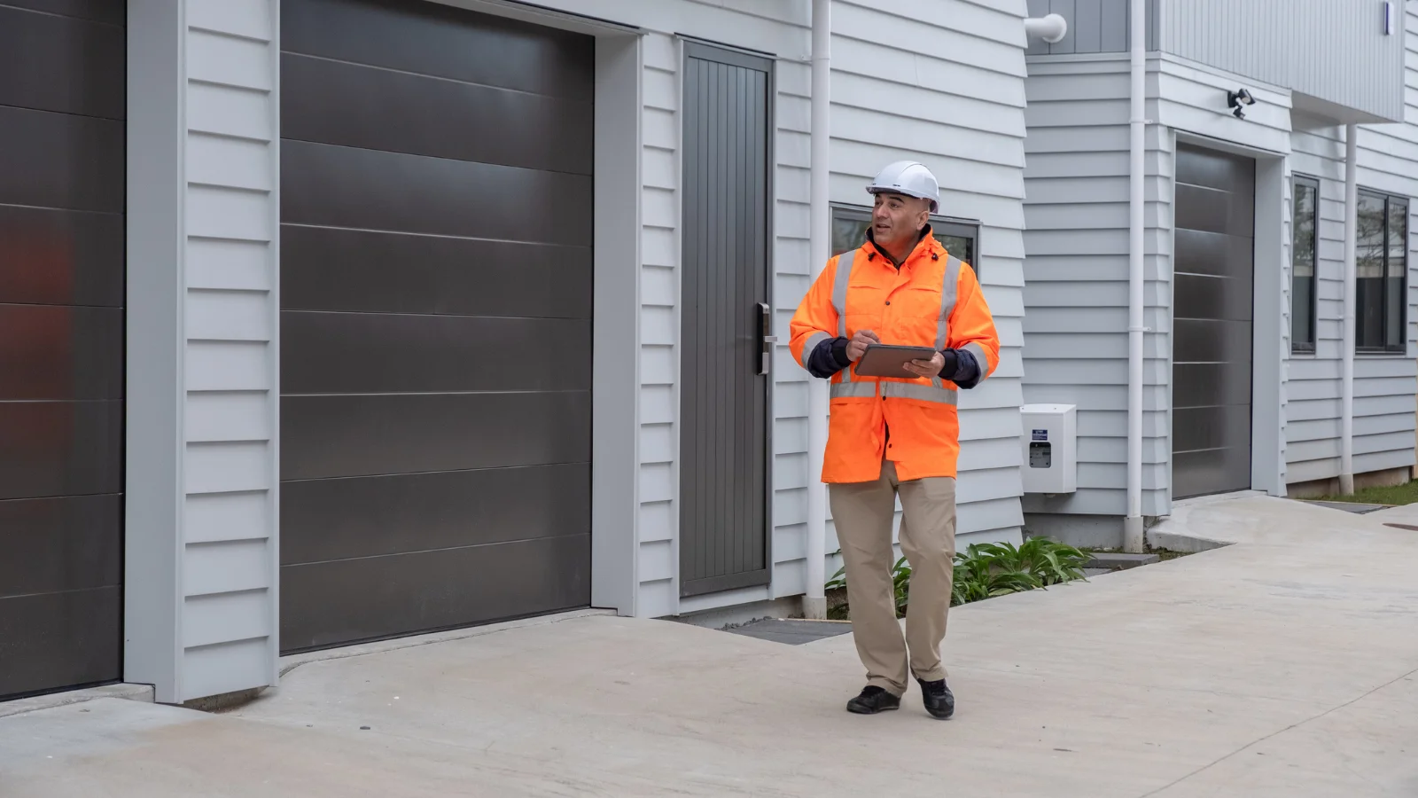 Man in vest looking at building. 