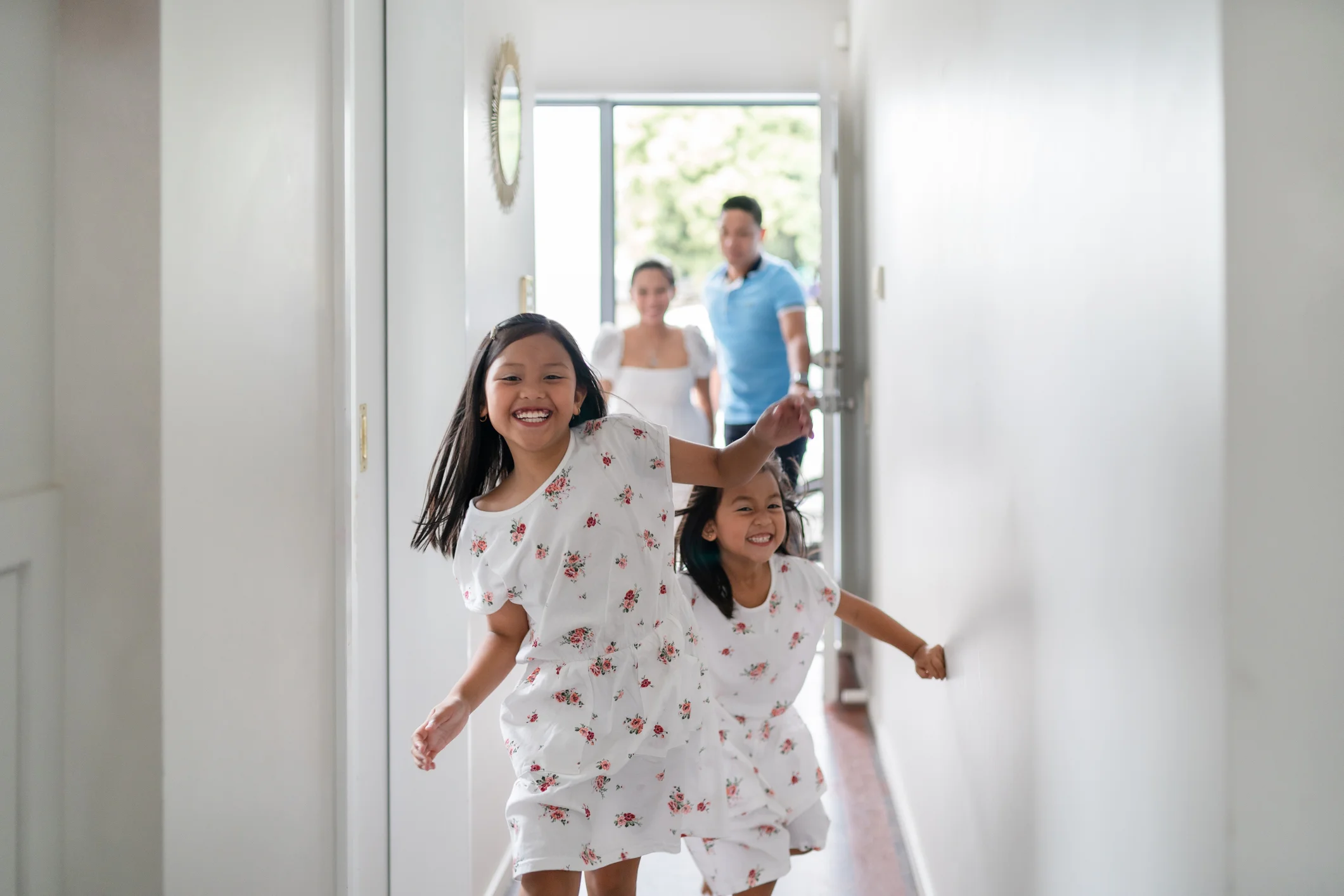 Family running into new home.