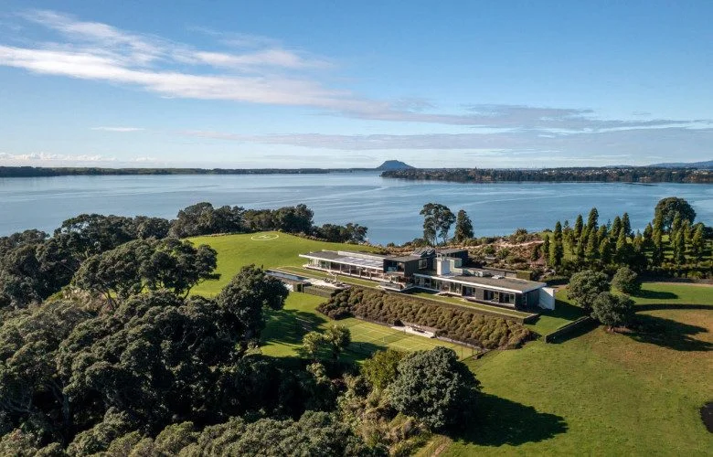 Modern waterfront mansion on Pahoia Road, Bay of Plenty, ranked among New Zealand’s most expensive houses, with sleek architecture, private helipad, and panoramic harbour view
