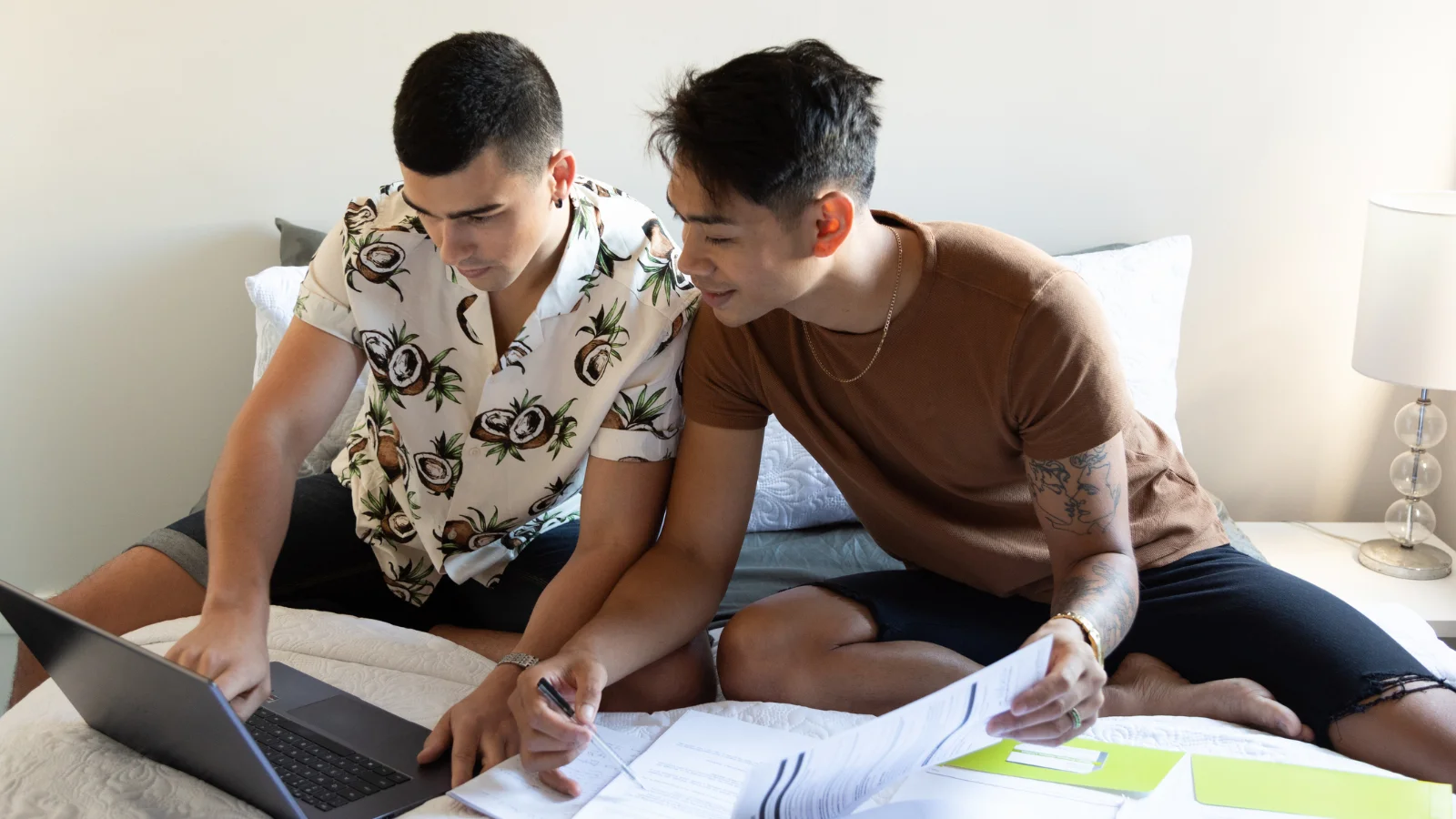 Two men looking at documents to buy a home.