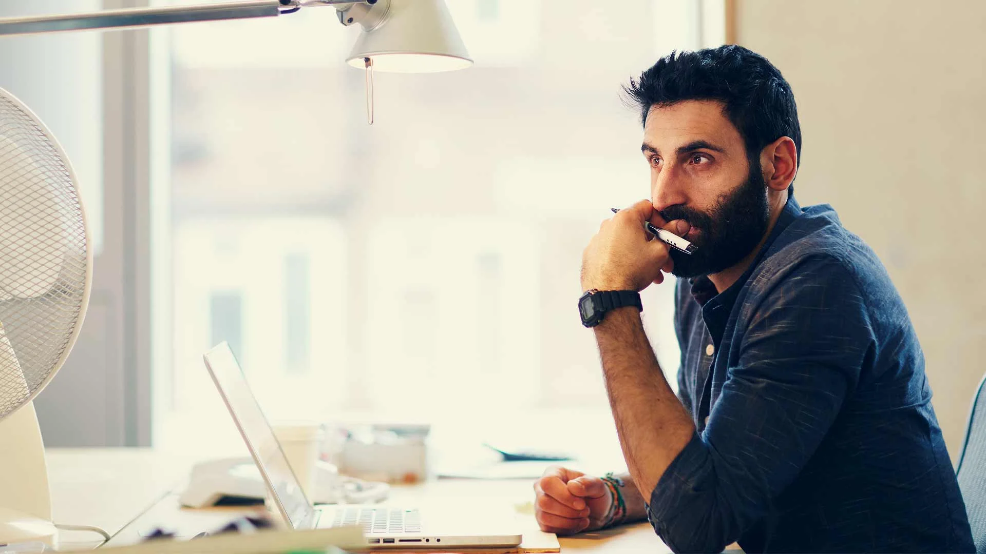 Man writing his CV after an absence from work.
