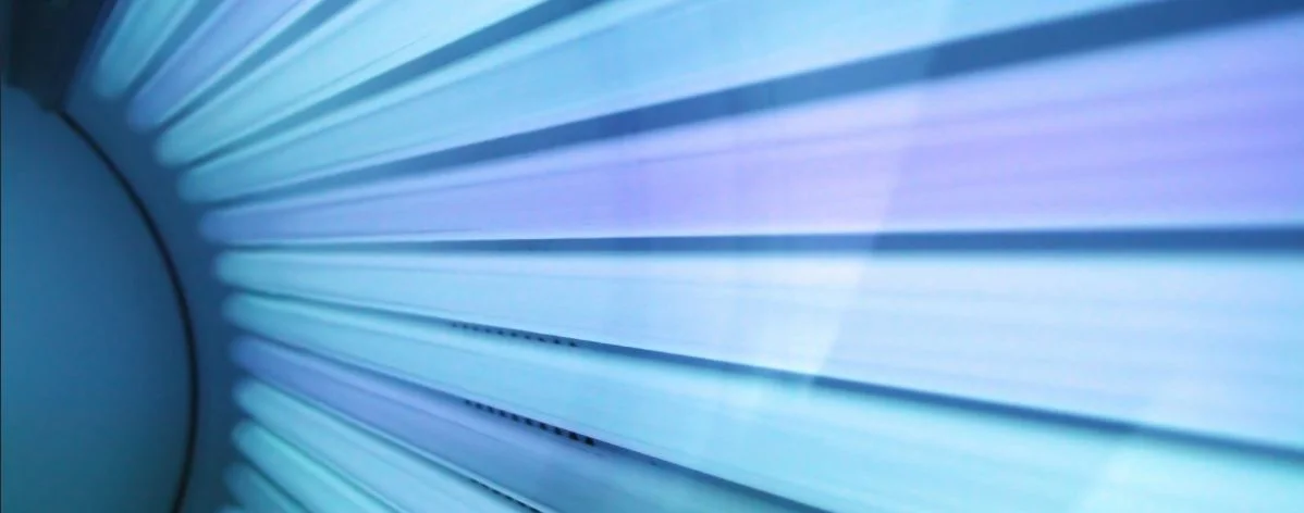 view along the illuminated blue sunbed uv tubes, gives the impression of starburst streams of light radiating out of the darkness