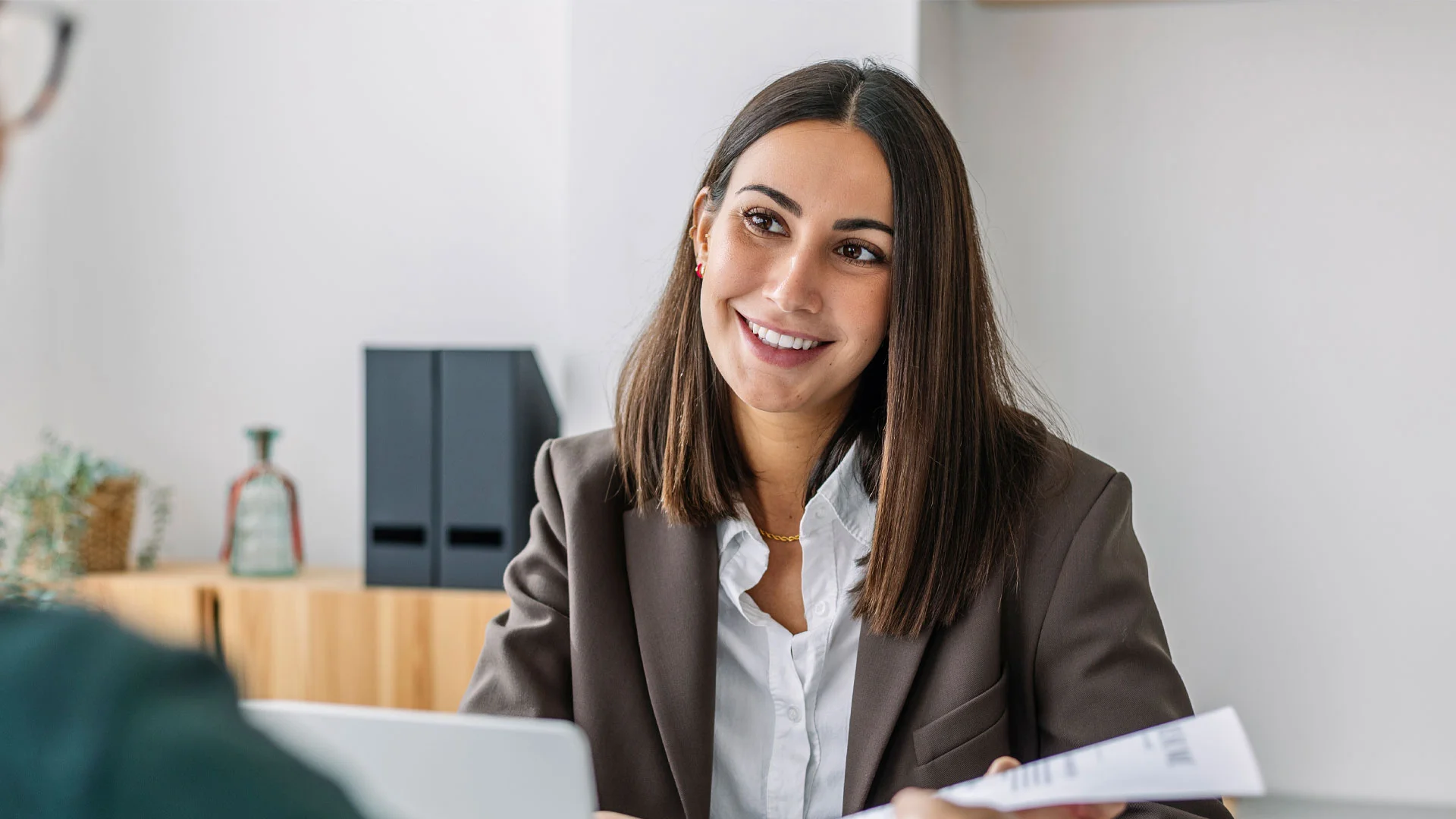 Female law job candidate sitting in a job interview answering a question.