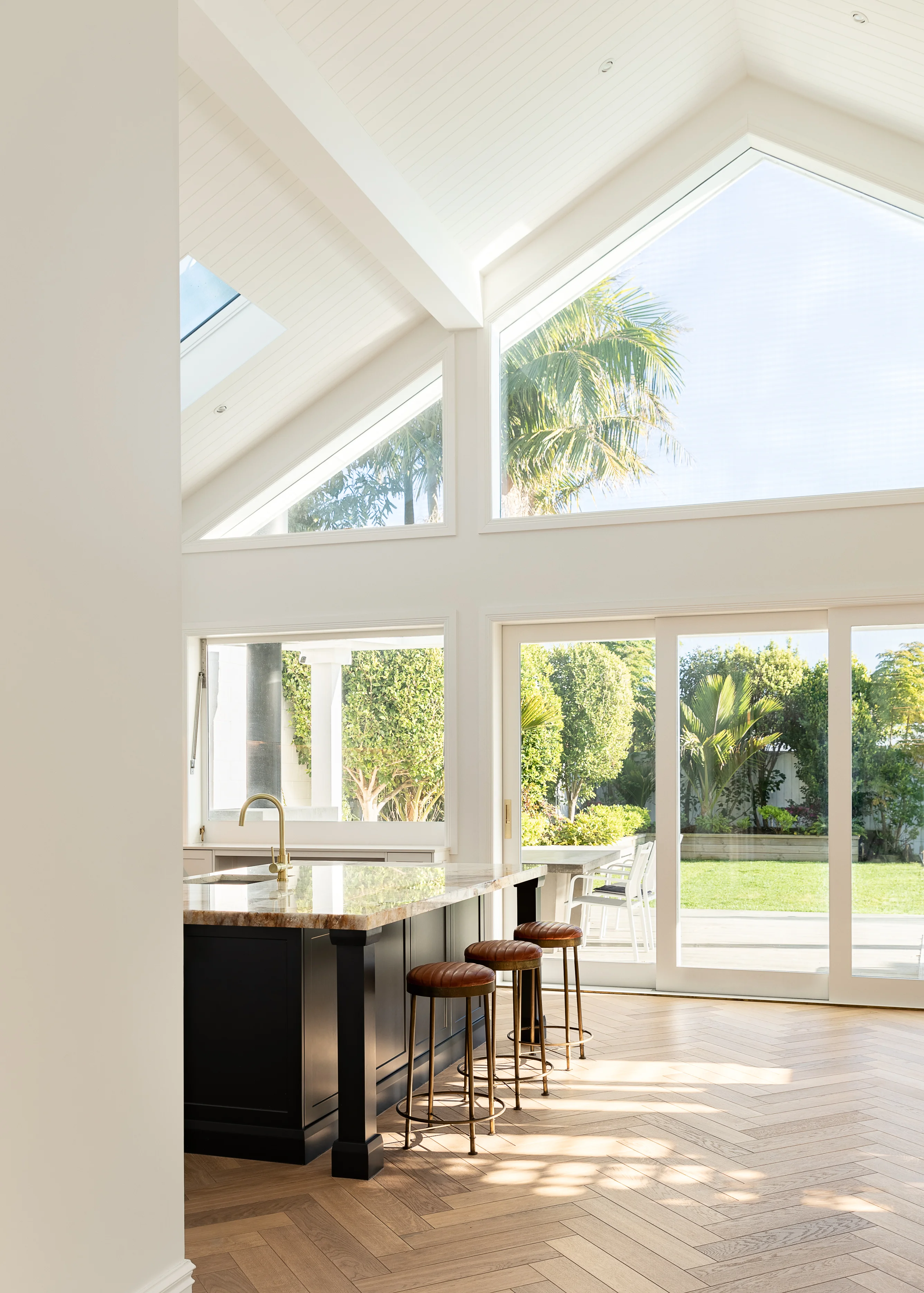 View of the kitchen island and gorgeous floor to ceiling windows