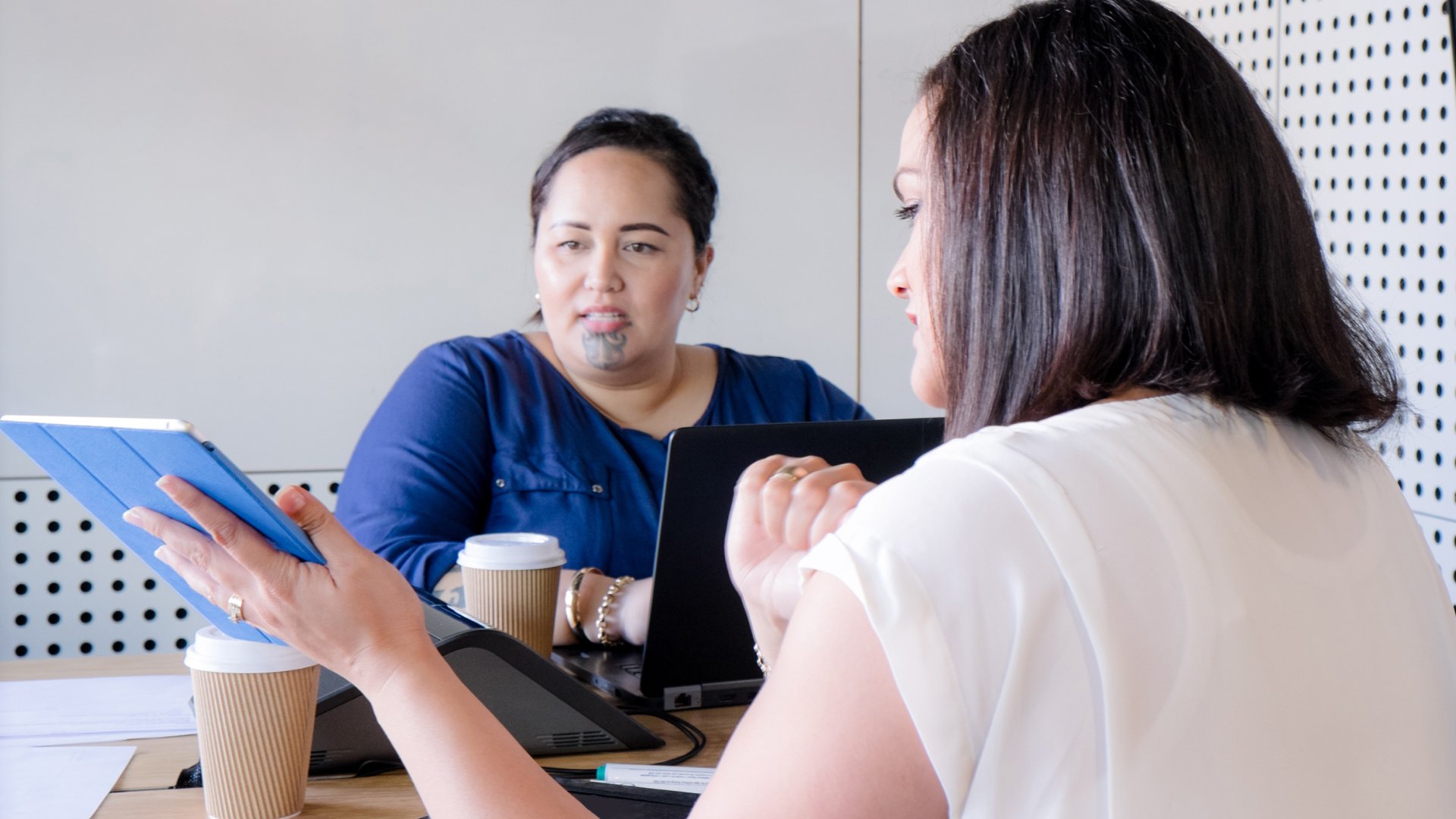 Woman shaking a hand in a meeting.