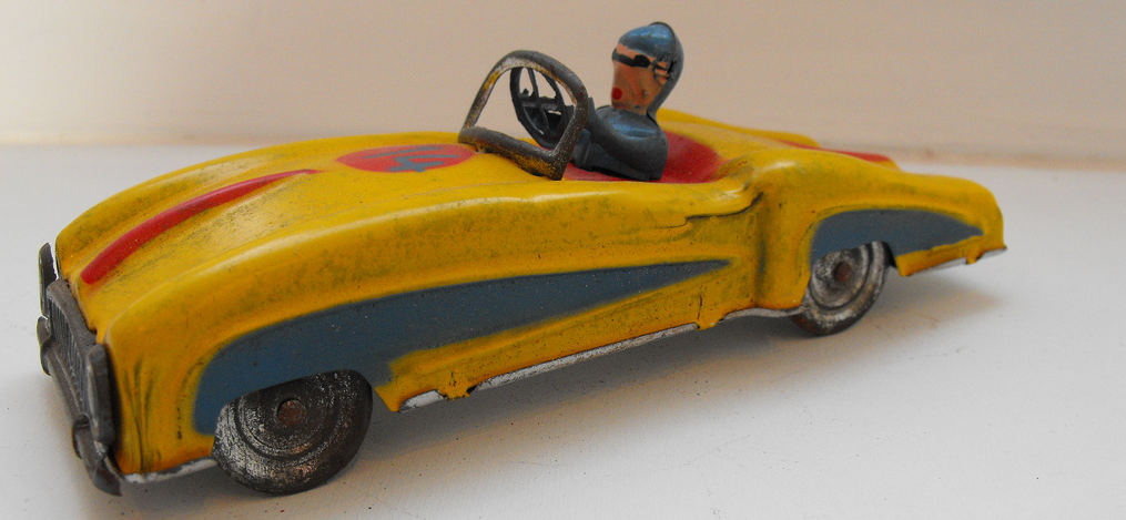 A vintage toy car with a driver