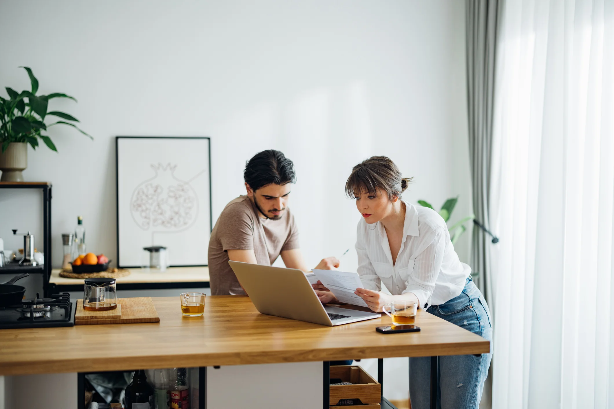 Couple looking at laptop in their kitchen