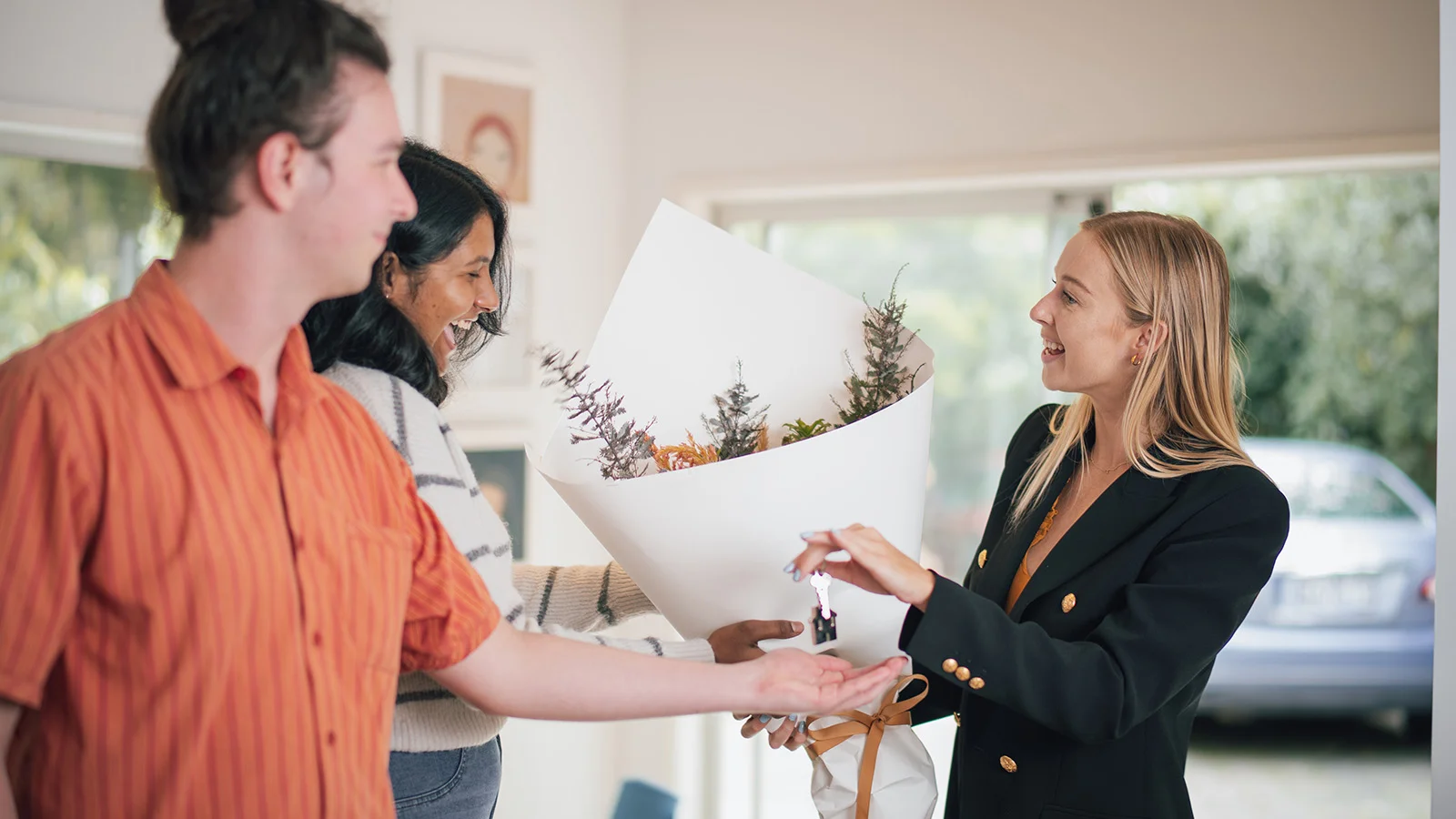 Buyers shaking hands with agent. 