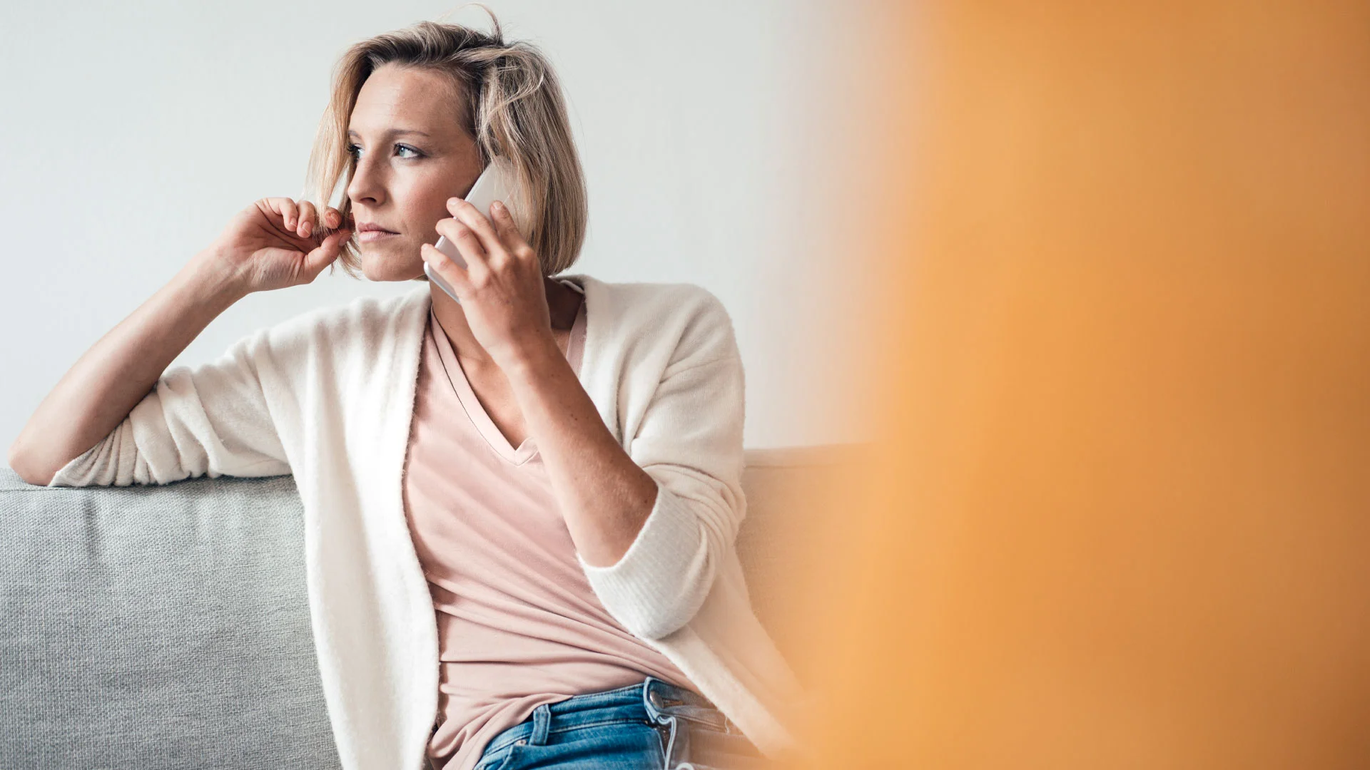 Employee talking to their boss on the phone at home.