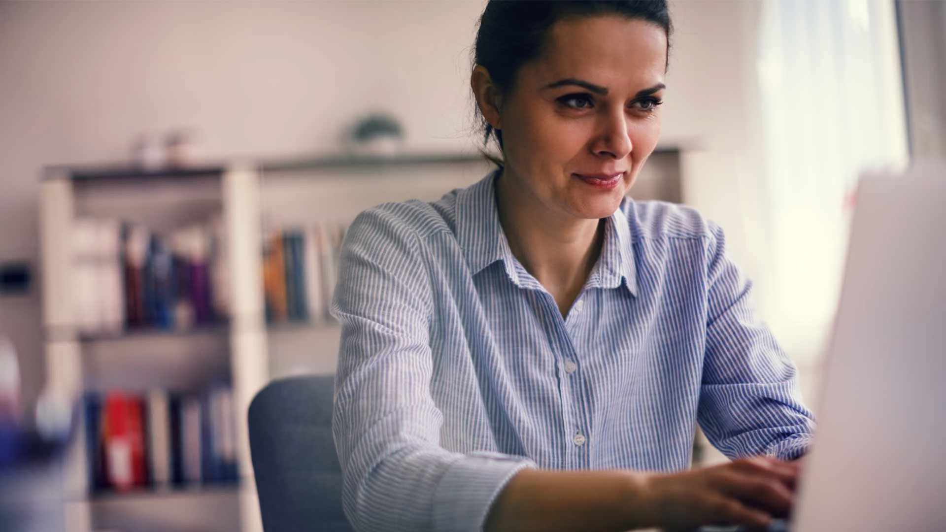 Woman typing on laptop