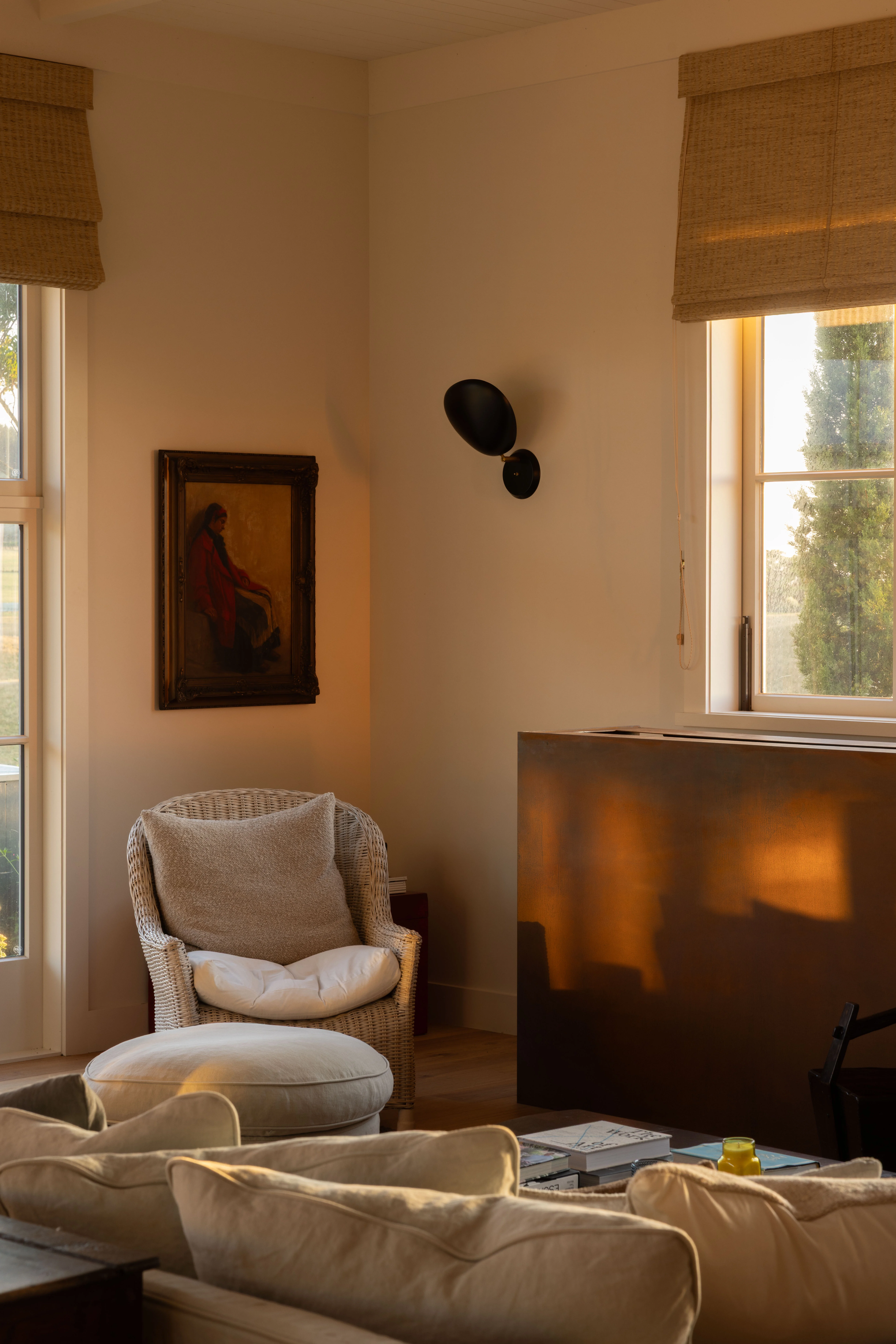 Judith inherited the 'girl in red', painted in the late 1800s by a Dutch artist, from her parents. It hangs above a rattan Gable lounge chair near an Axel Vervoordt-designed sofa, imported by Tiel Interiors. Judith loves to read in front of the fireplace, which is clad in weathered steel. Mainly she enjoys Dutch autobiographies and she likes to keep up with new Dutch authors.