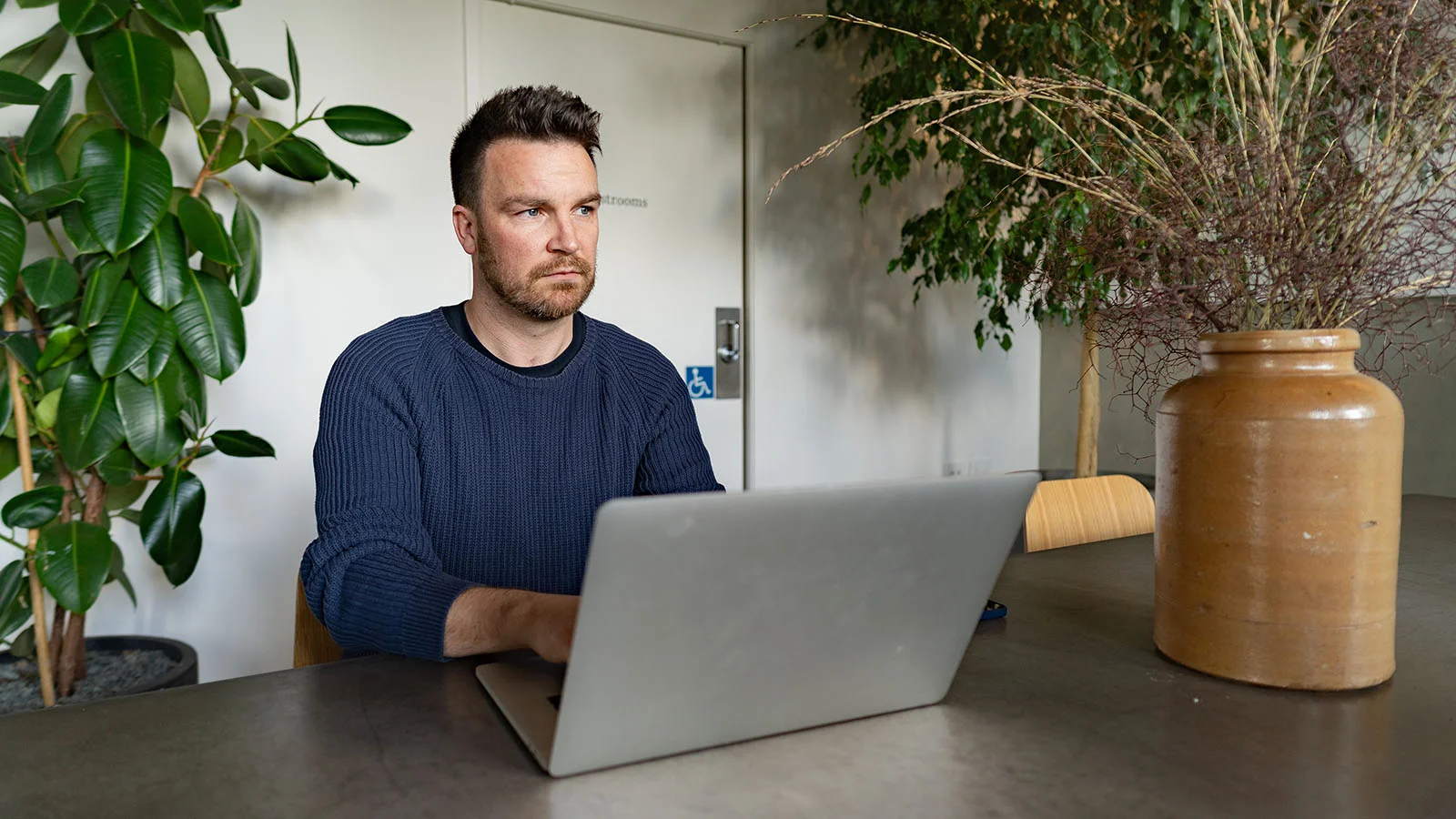 Man at work worrying about money