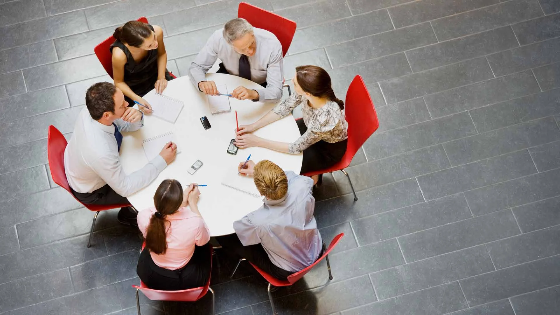 Team meeting around a circular table.
