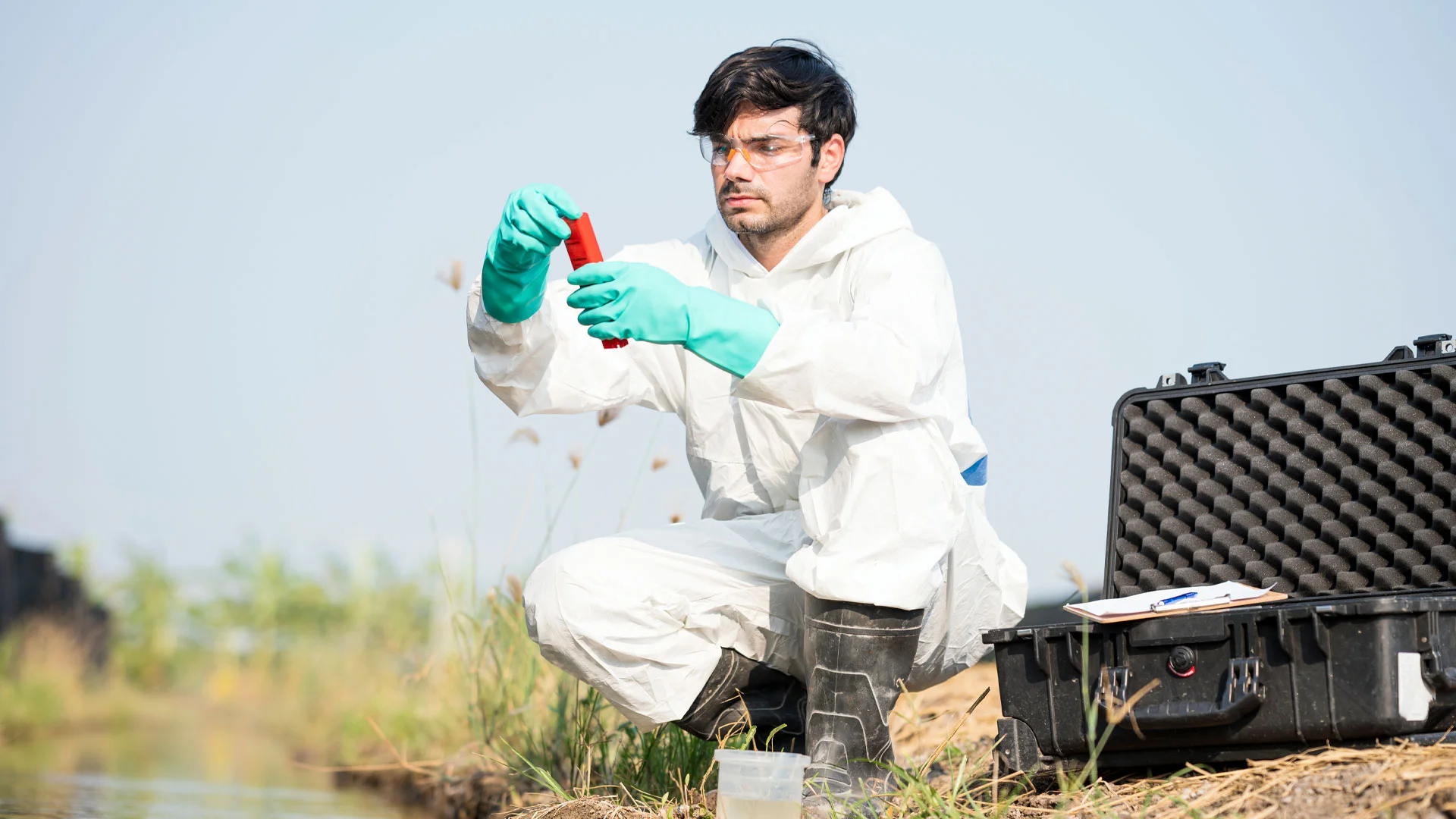 Council employee testing the water quality of a stream in Aotearoa New Zealand.