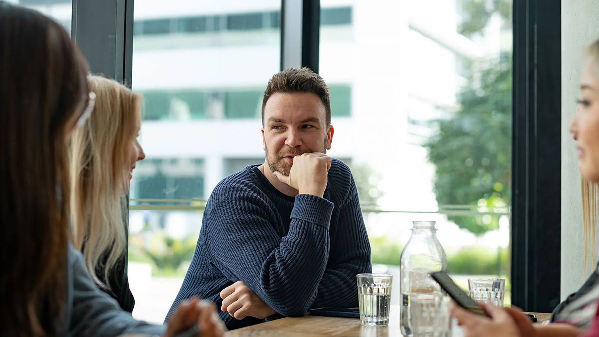 Colleages talking about payrises together at work.