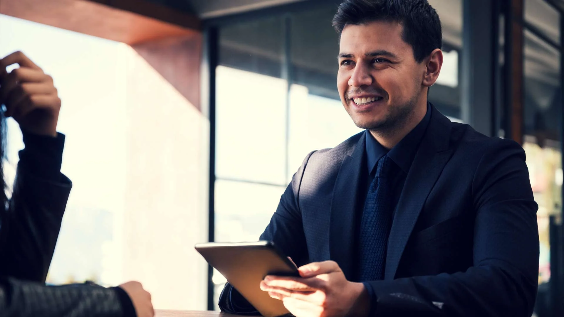 Hiring manager in a job interview with a tablet.