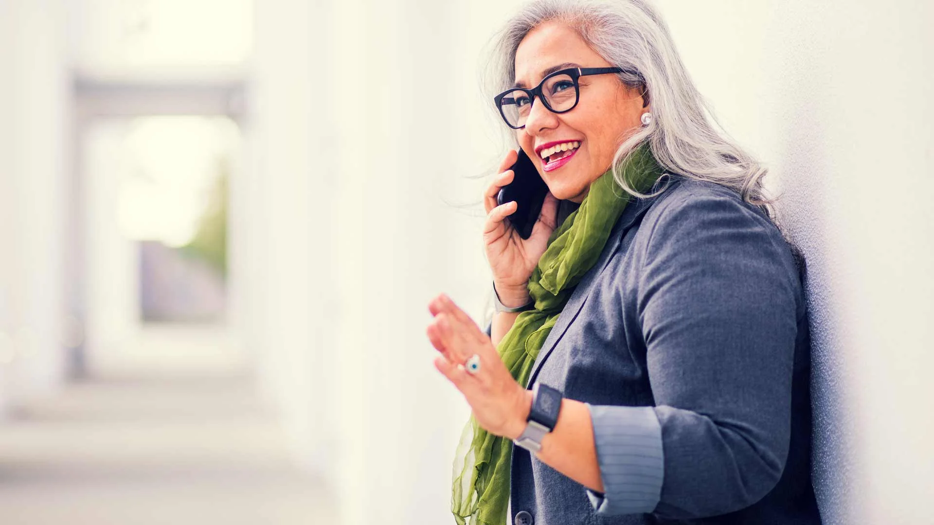 Candidate talking to a hiring manager on the phone in a hallway.