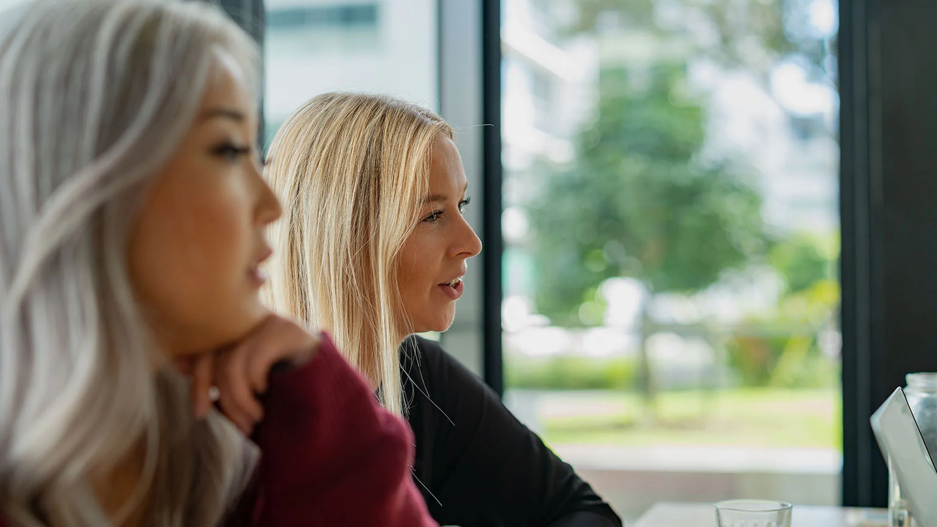 Two young female interview candidates sitting in a group job interview