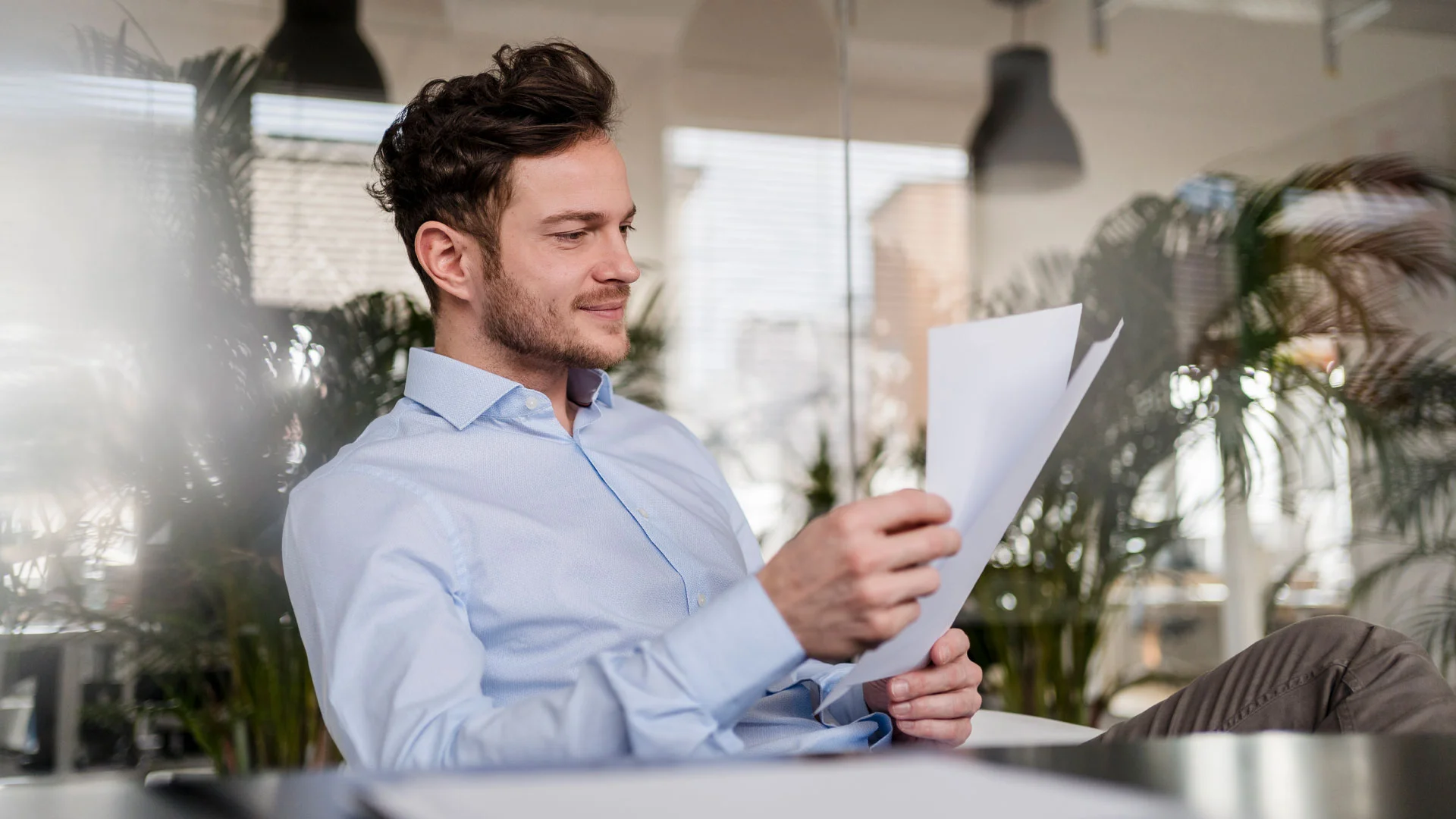 Recruiter reading a cover letter in his office at work.