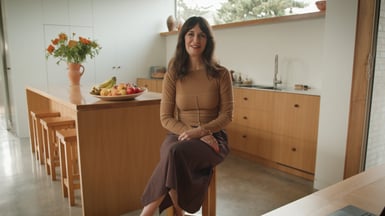 Lucy Coote sitting in her kitchen in Berhampore.