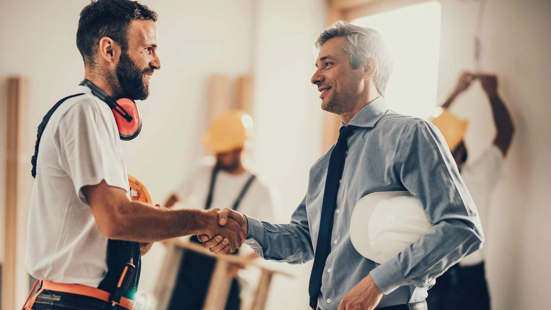 Man shaking hands with his boss after resigning with grace.
