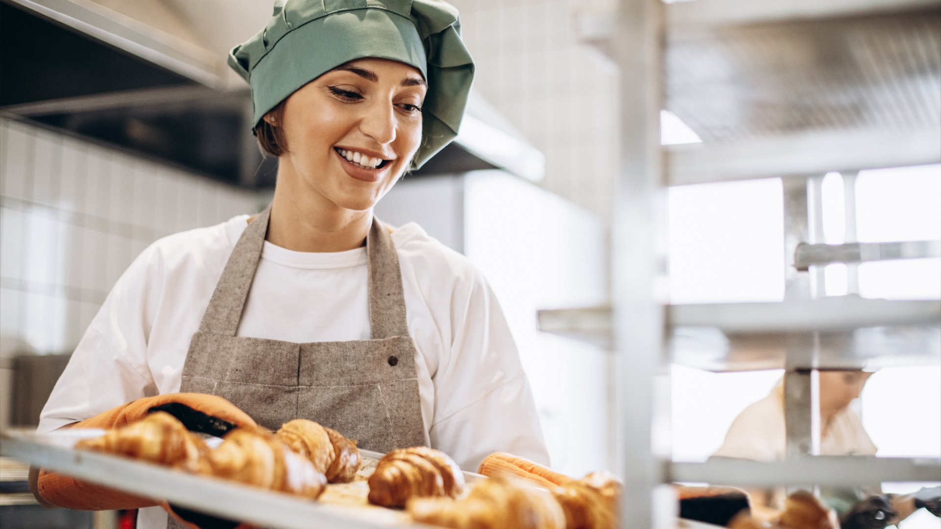 Female baker baking croissants