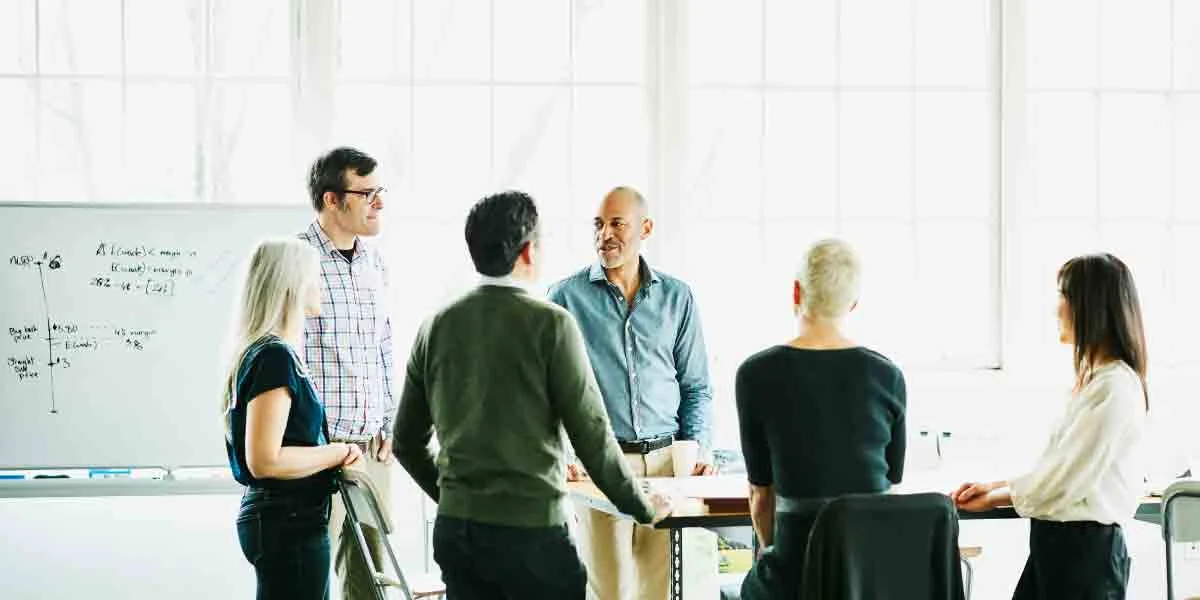 A group of senior business people talking about results.