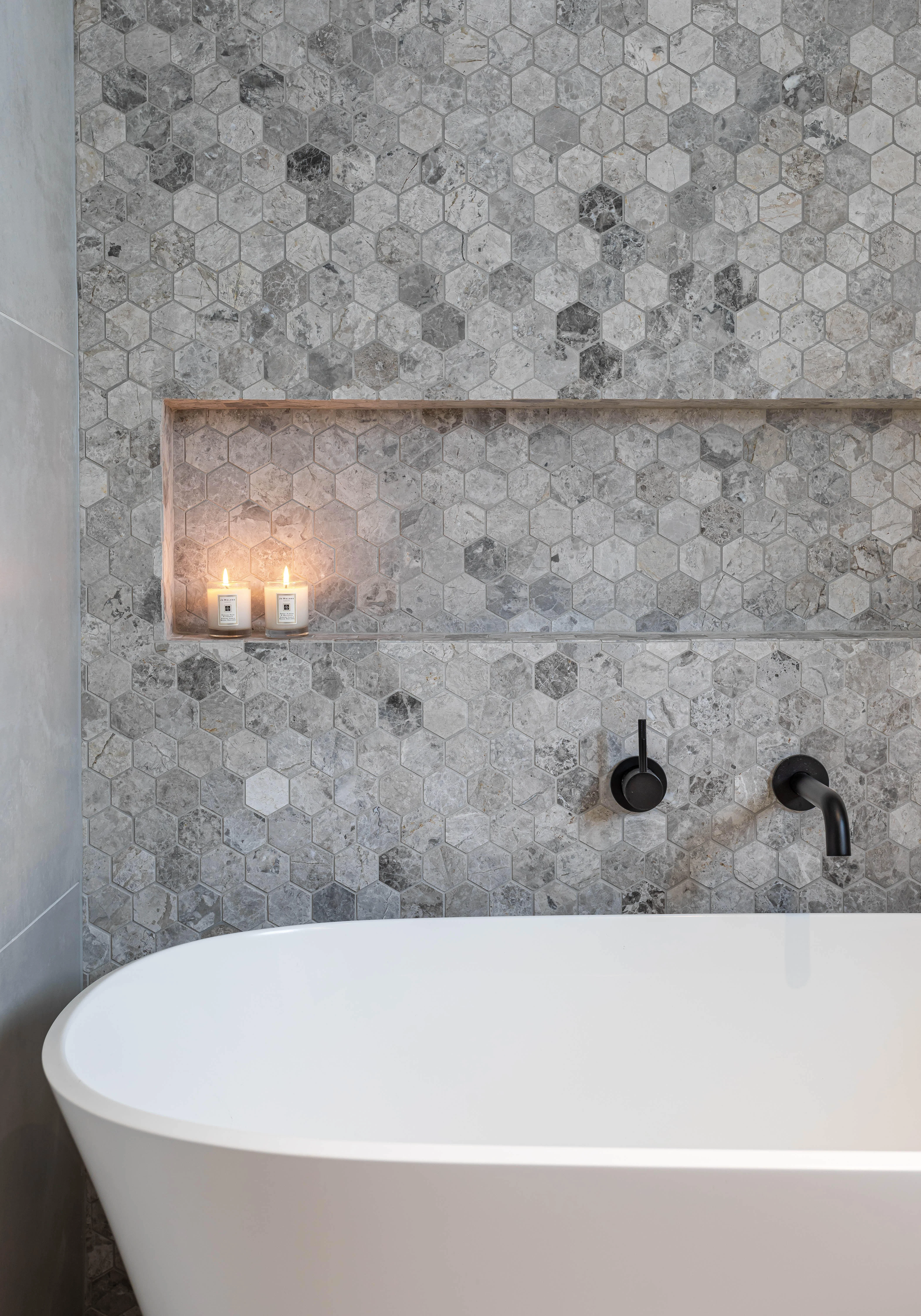 Bathtub in tiled bathroom