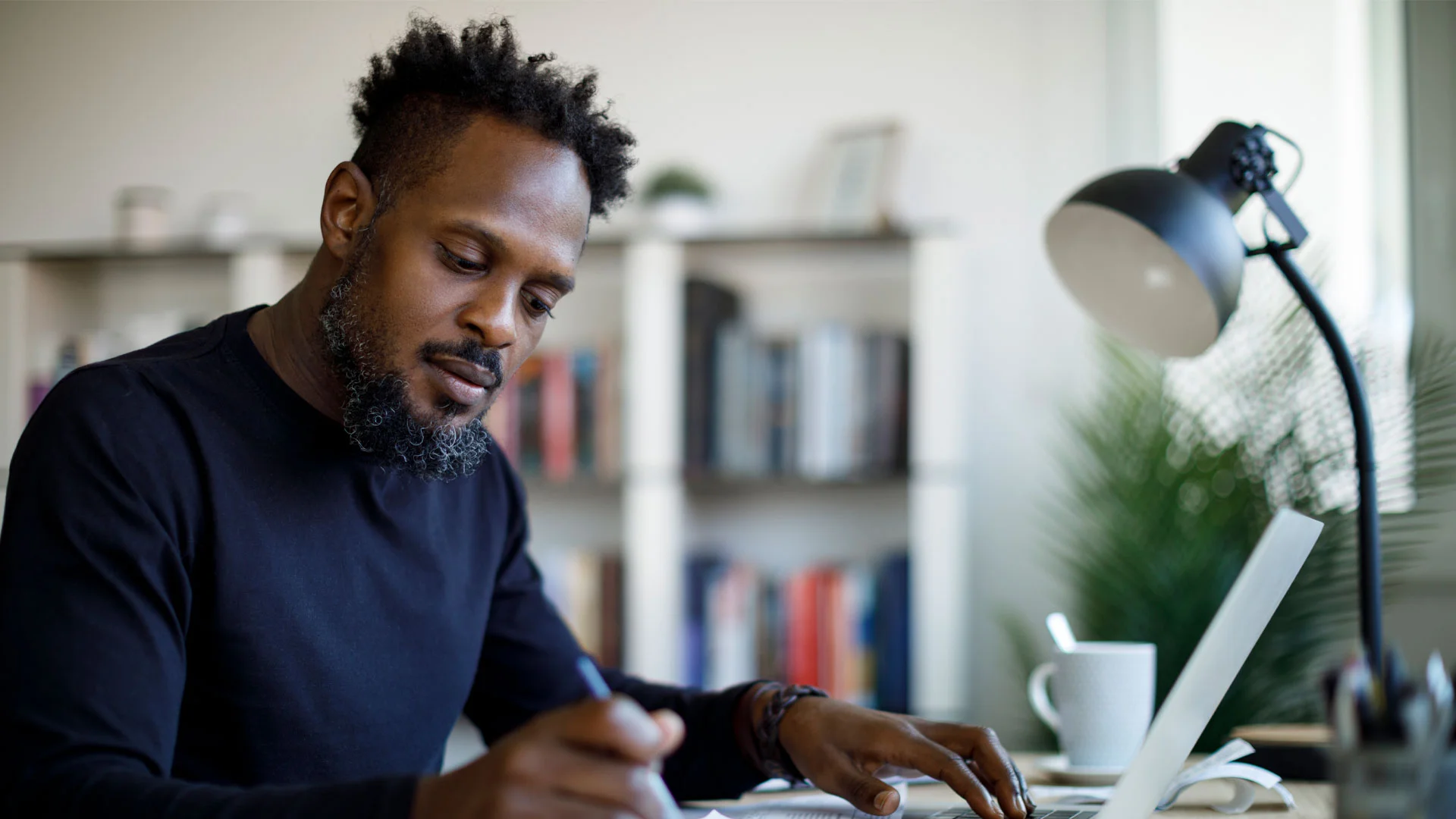 Employee creating a how-to guide for a new starter.