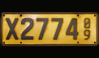 Yellow trade licence plate with black printing X2774 09