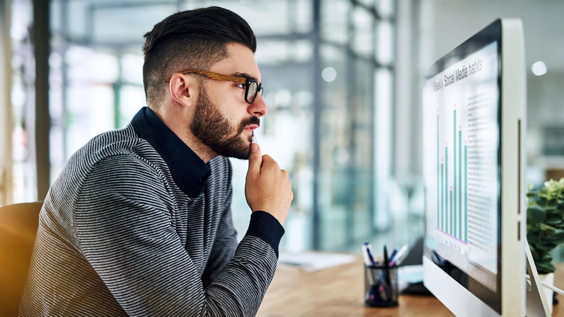 Man staring at his computer at work.