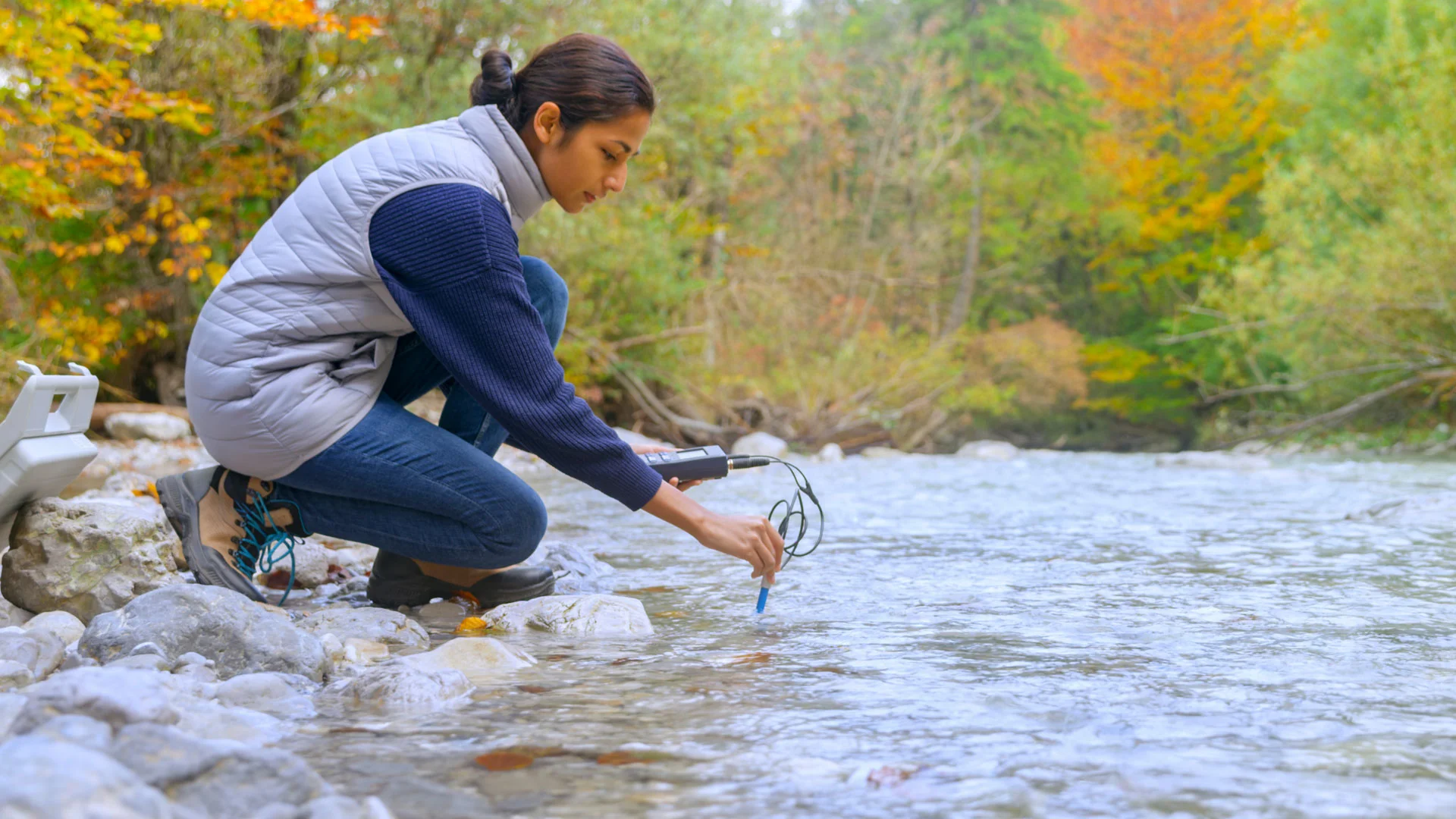 Young scientist testing the quality of a freshwater stream.