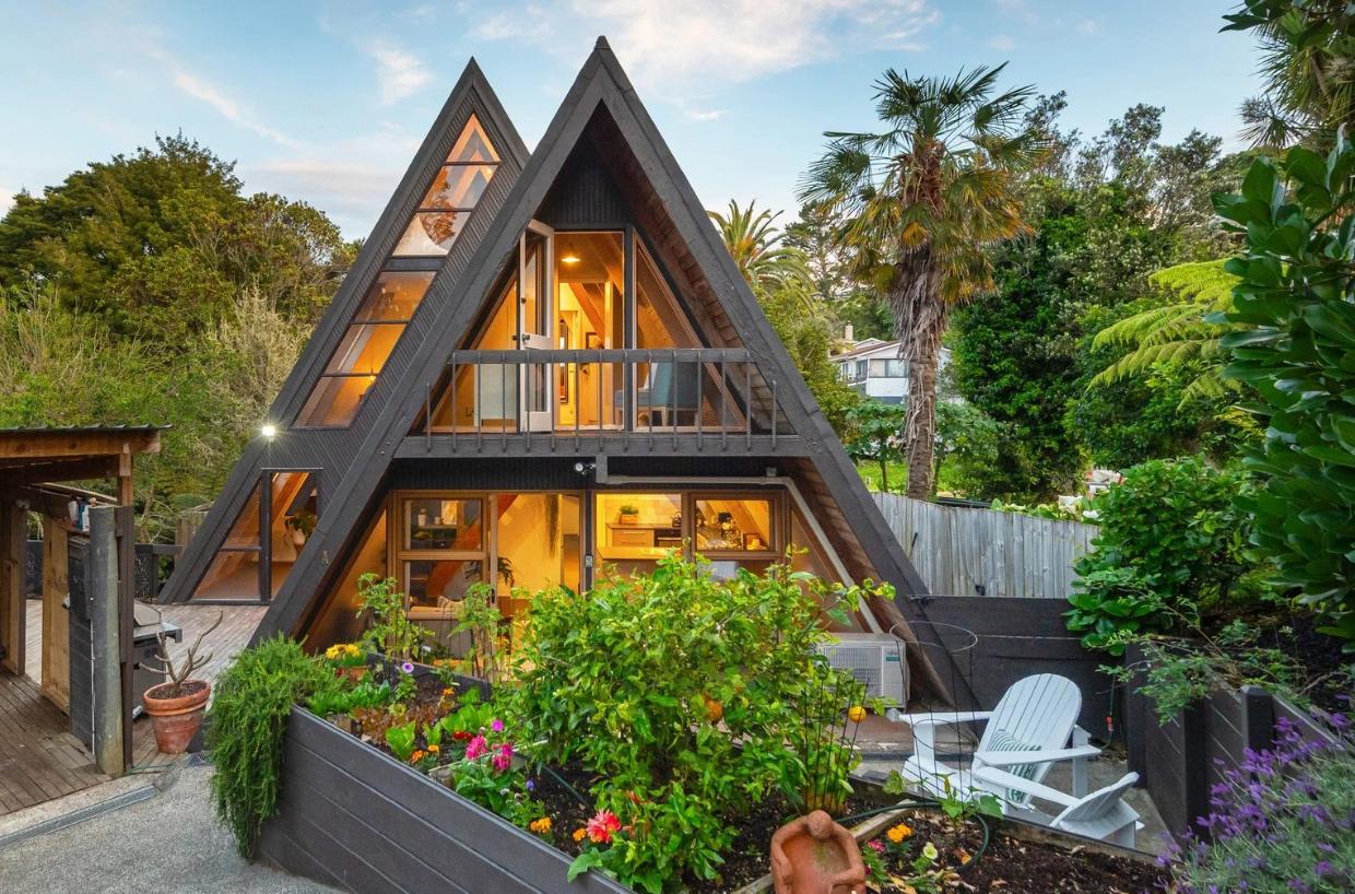 While still recognisably an A-frame, this home has had two major transformations in the past 40 years that have completely modernised the house. Photo: Harcourts