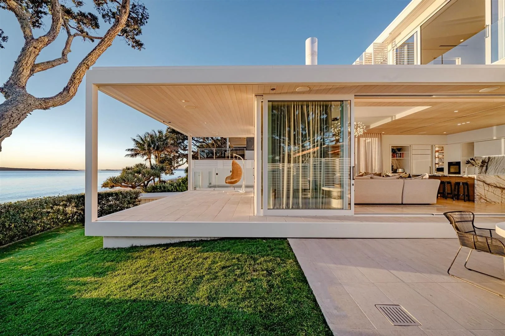 Modern luxury waterfront home in Takapuna, Auckland, ranked among the most expensive houses in New Zealand, with open-plan living, sleek architecture, and sweeping ocean views.