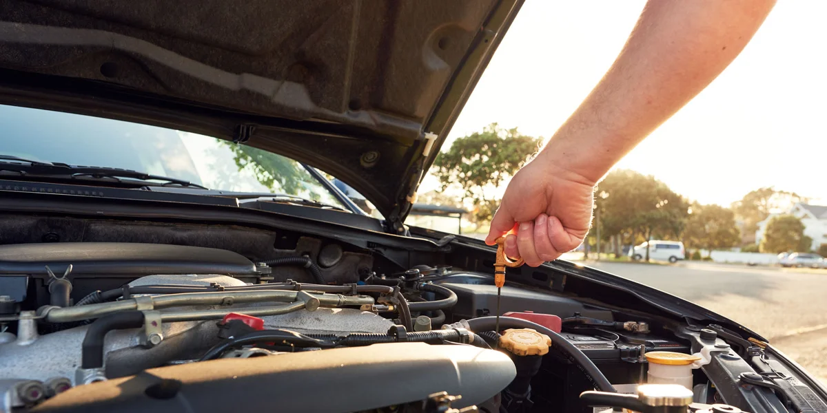 Mechanic checking under bonnet