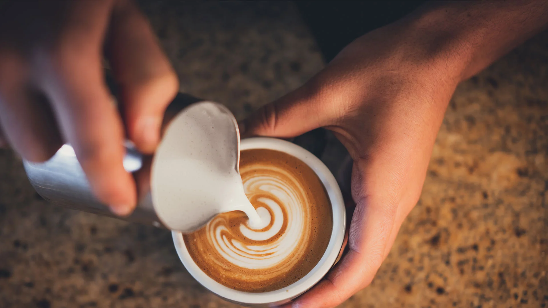 Barista making a coffee in New Zealand.