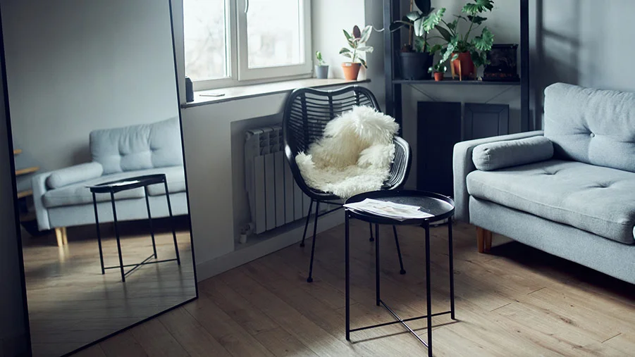  A New Zealand living room with a full-length mirror positioned by the window to make the room feel bigger.