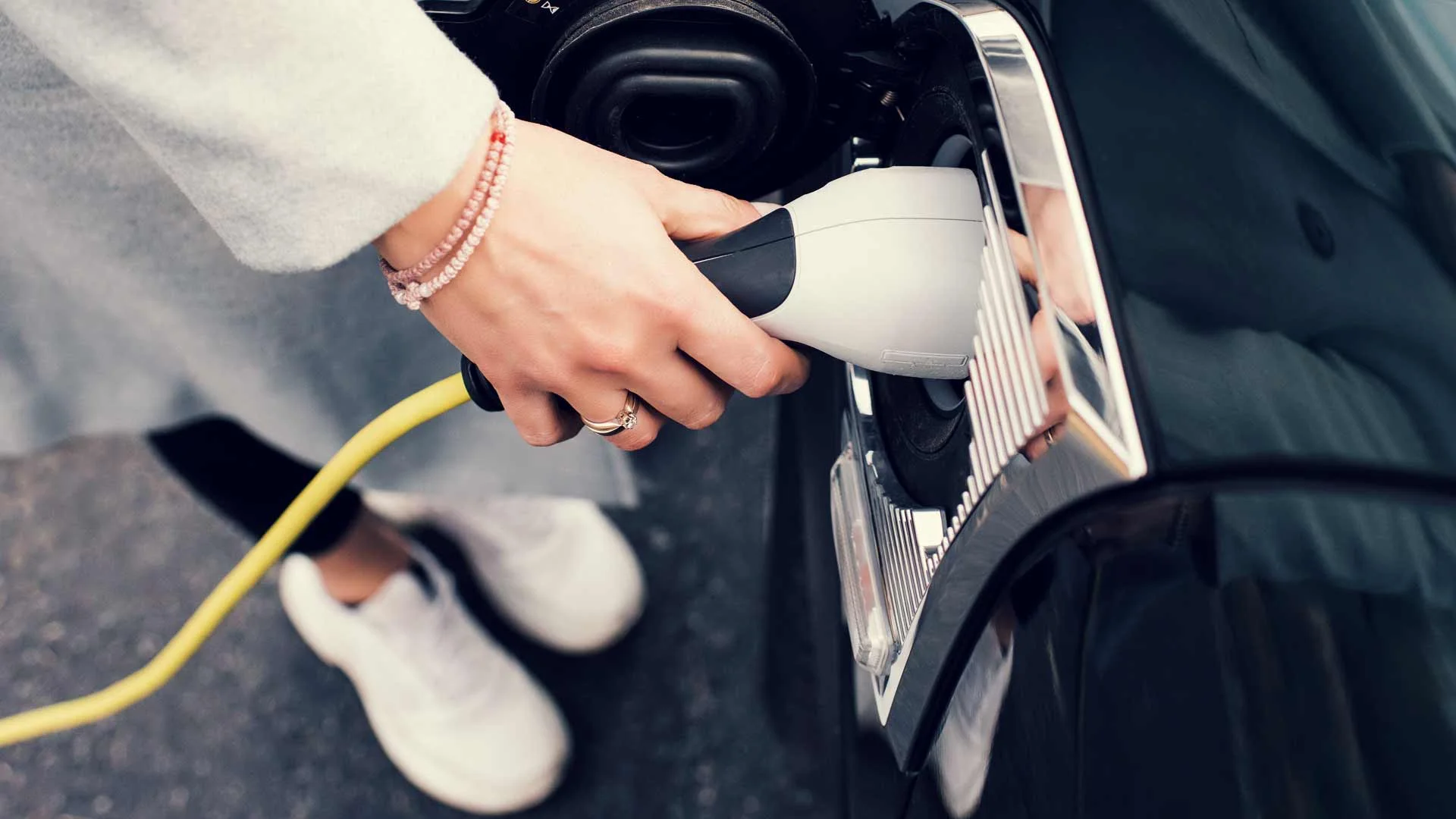 New Zealand woman charging her electric vehicle in 2020.