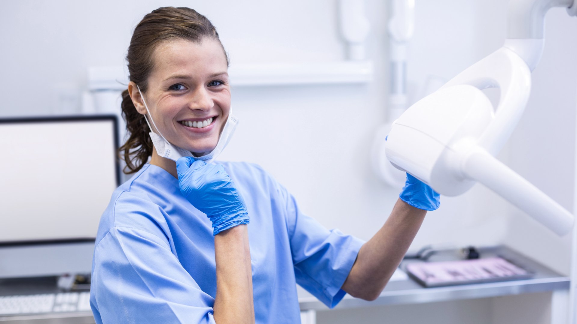 Dental assistant using dentistry machinery