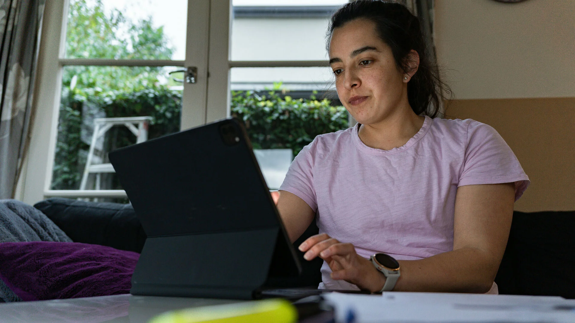 Woman writing a cv on her laptop at home.