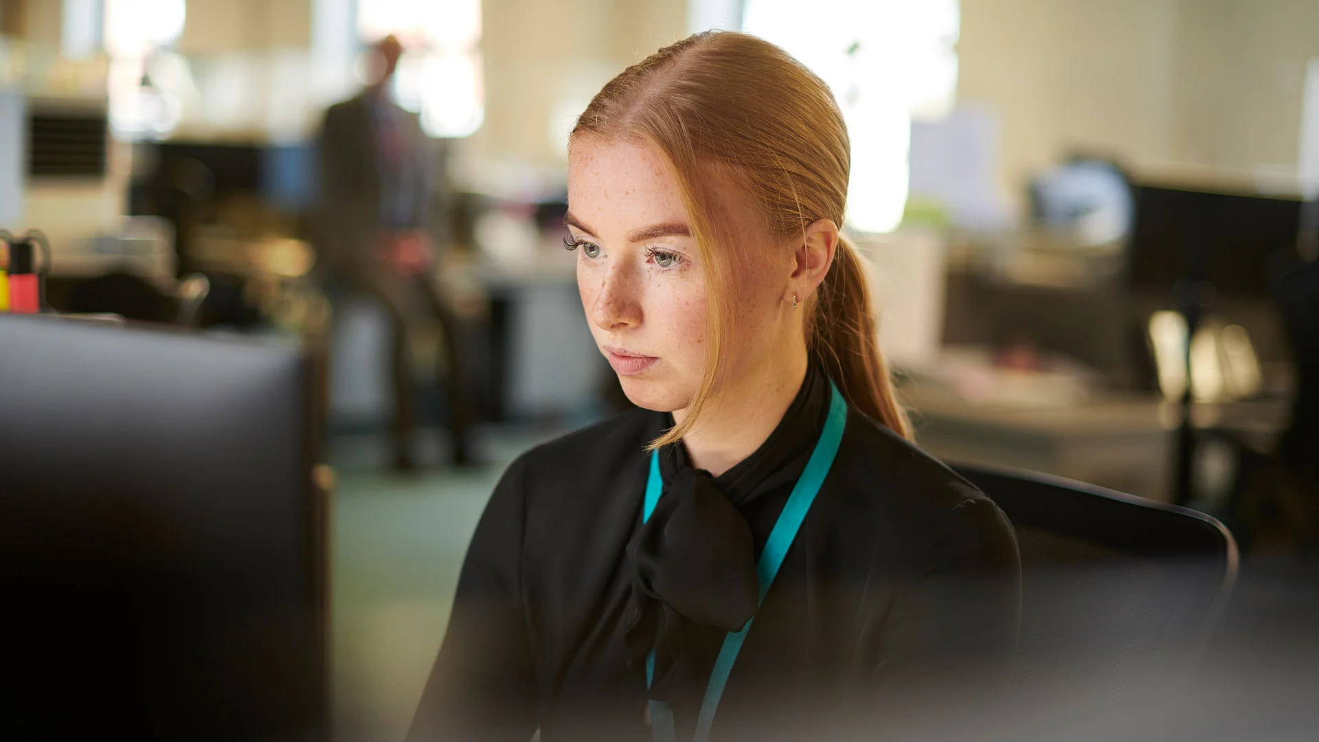 Young employee working in her first graduate job in New Zealand.