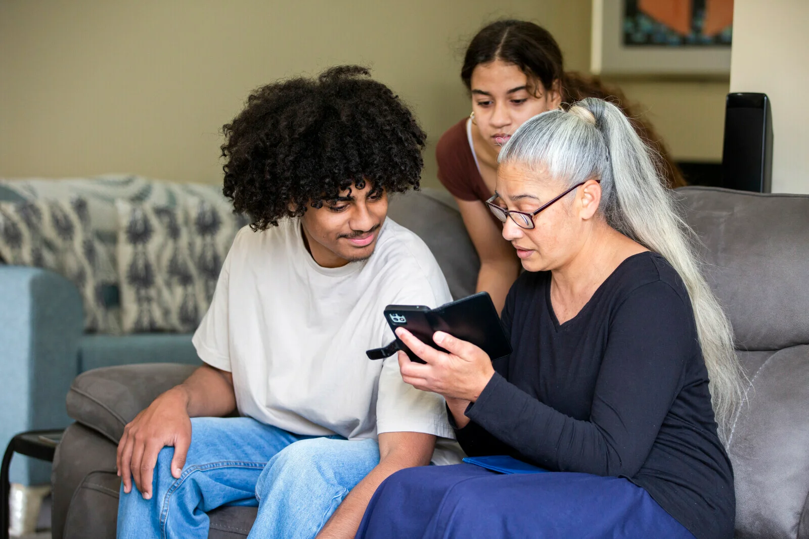 Family looks at a phone