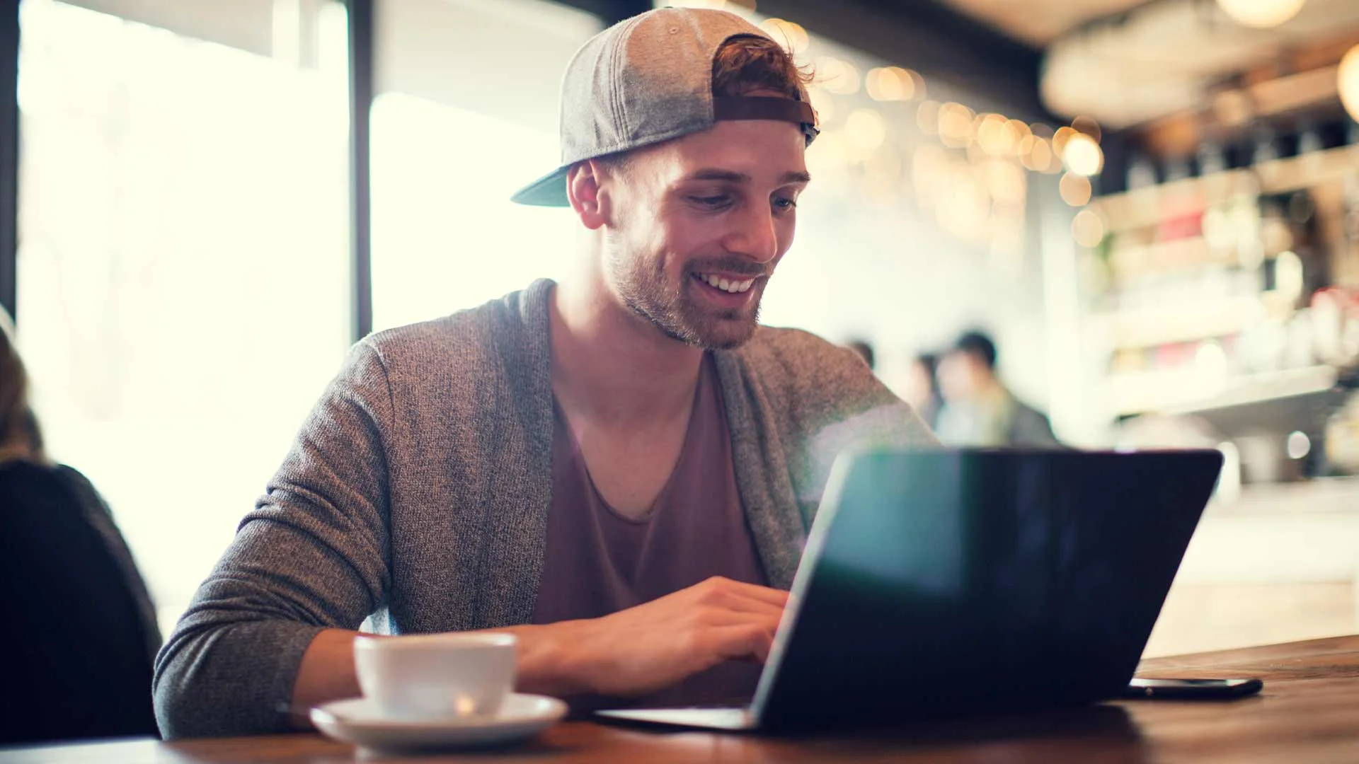 Young man researching jobs on laptop.
